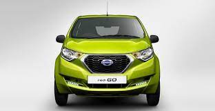 An image of a Datsun redi-GO car displayed on a website with the text 'Price under 7 lakhs' written in bold letters above the car. The car is a compact hatchback with a sleek design and is available in different colors. It has a modern front grille, stylish headlamps, and a smooth contour that runs along the length of the car. The background of the image is a plain white color, and the car is situated in the center of the frame, with no other objects visible in the background.