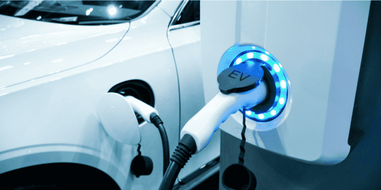 An image of an electric vehicle (EV) charging at a charging station, with the charging cable connected to the EV's charging port. The image emphasizes the importance of EV charging infrastructure for sustainable and eco-friendly transportation, and showcases the EV's charging process.